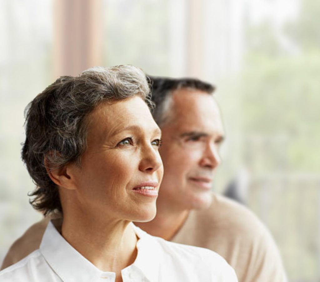 Distinguished man and woman looking to the right into the distance, blurred background